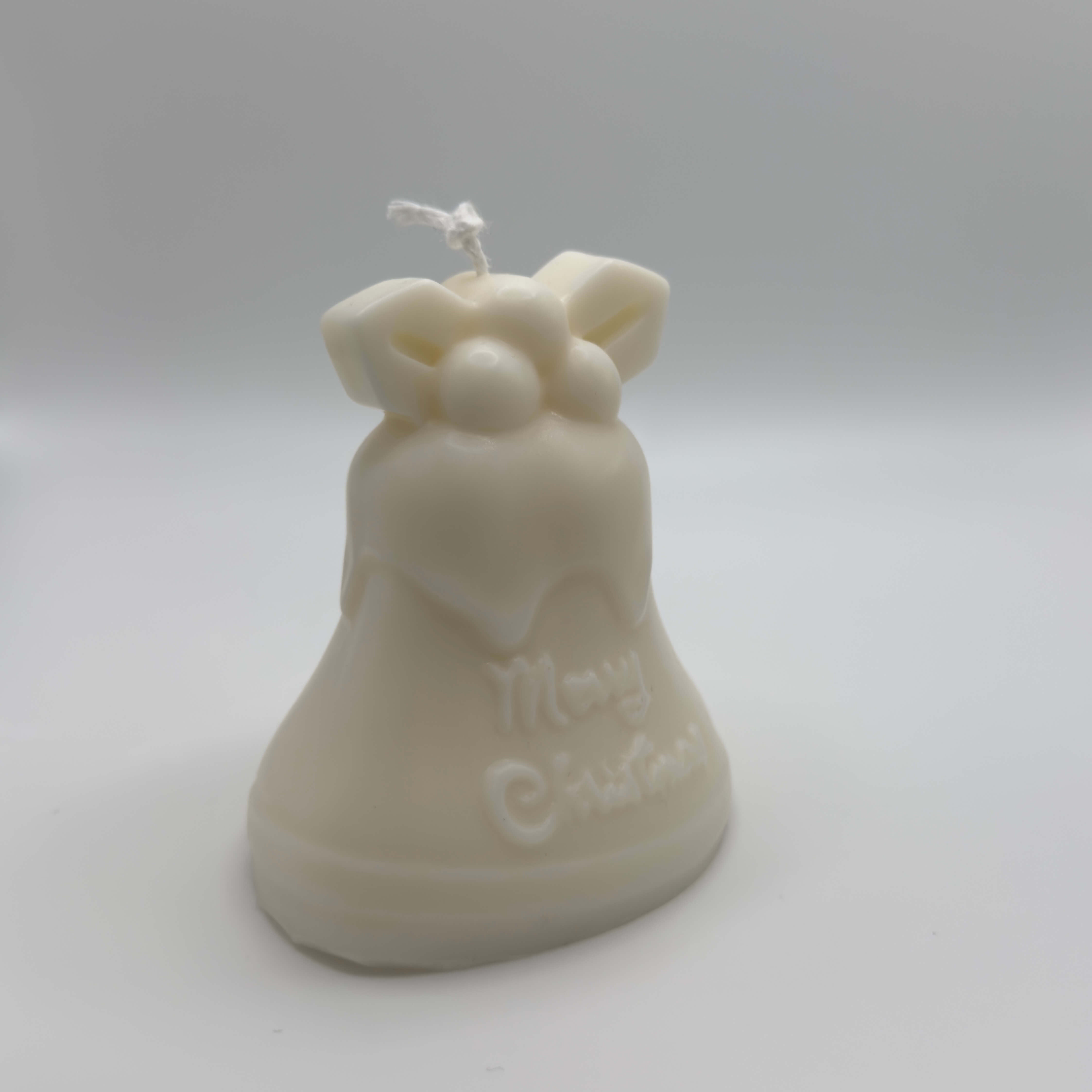 Mistletoe Bell Sojawachs-Kerze in Glockenform, umweltfreundlich aus Sojawachs mit festlichem Mistelzweig und ‘Merry Christmas’.