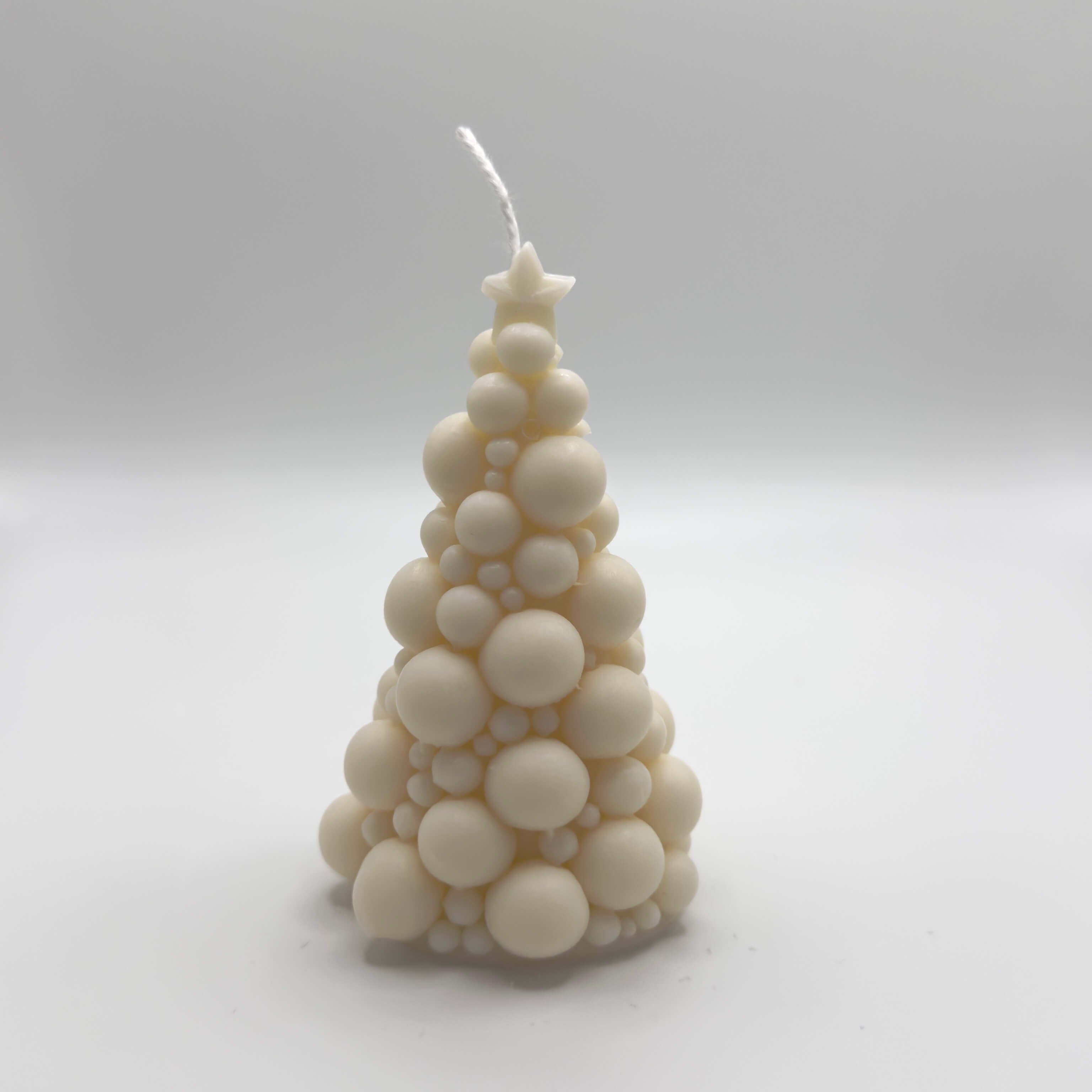 Bubbly Christmas Tree Candle, kreative Weihnachtsbaum-Kerze aus Bubbles mit einem glänzenden Stern für festliche Dekoration.
