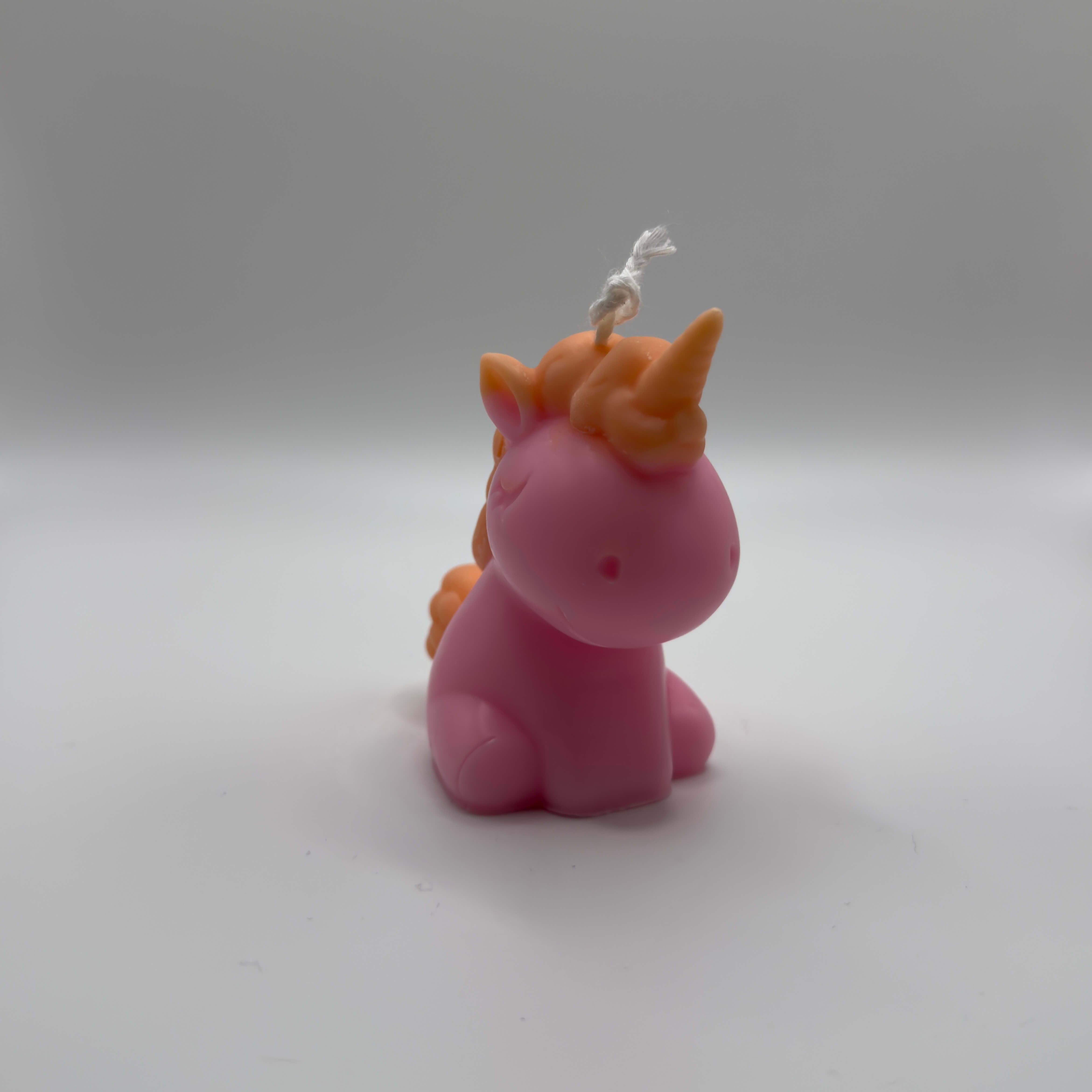 Rosa Celestial Unicorn Einhornkerze mit orangenem Schweif und Horn aus natürlichem Sojawachs – handgemachte Fantasy-Kerze für Fans von Einhörnern.